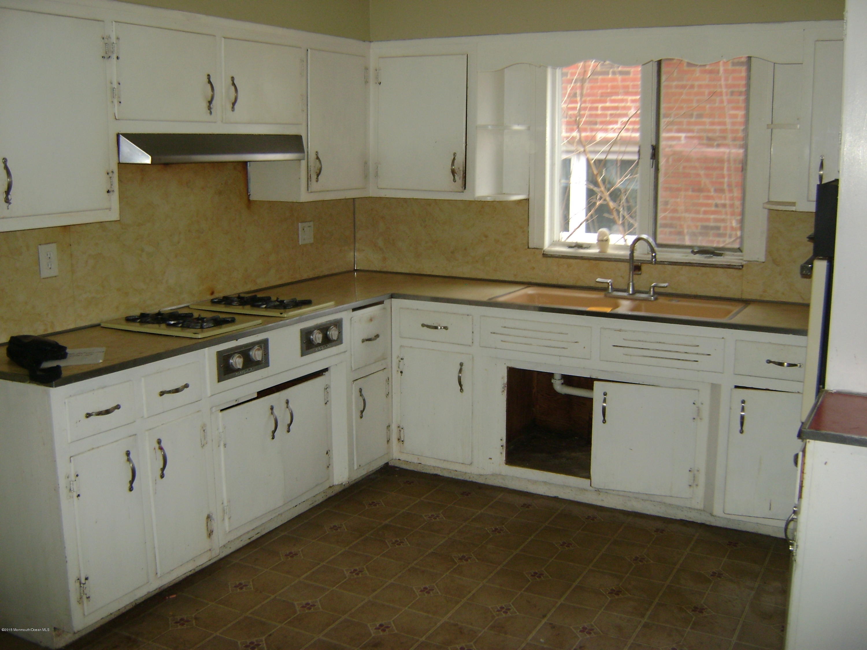 9 Howland Avenue Long Branch, NJ 07740 - Photo 3 of 11 a kitchen with granite countertop white cabinets and window