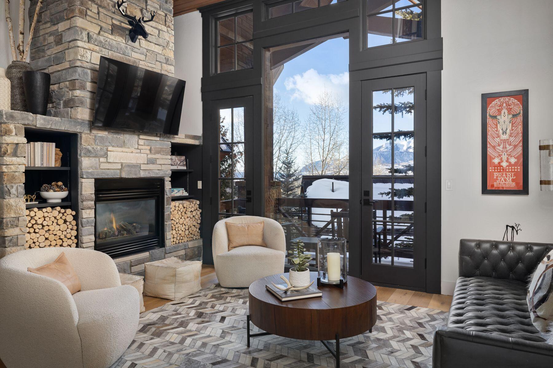 a living room with furniture a flat screen tv and a fireplace
