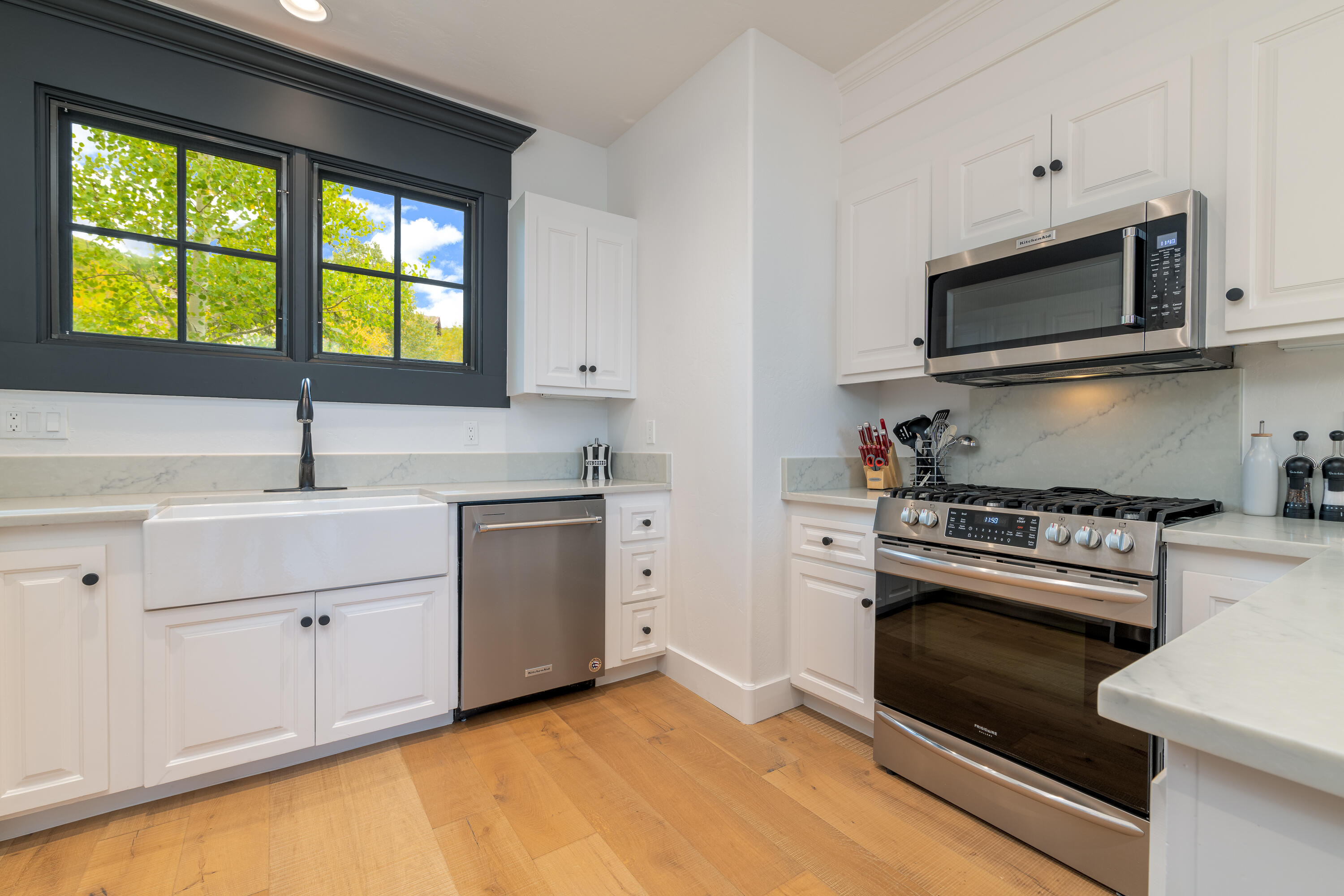 101 Sunny Ridge Place, Unit 101 Mountain Village, CO 81435 - Photo 12 of 30 a kitchen with a stove a sink and a microwave