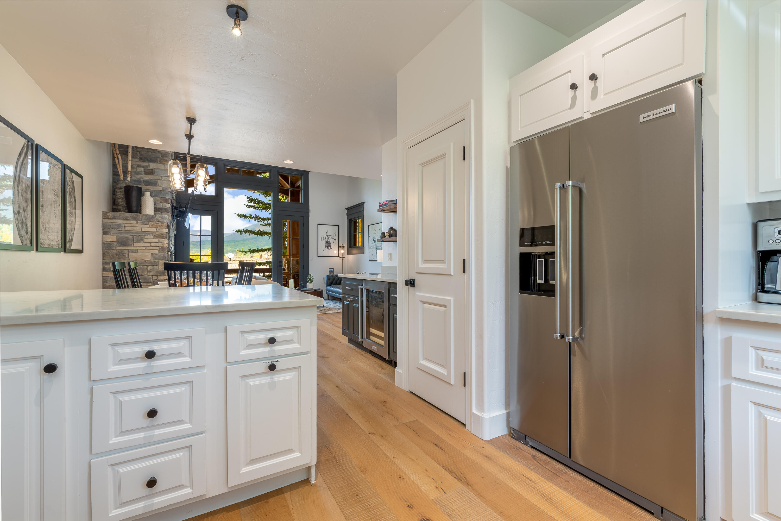 101 Sunny Ridge Place, Unit 101 Mountain Village, CO 81435 - Photo 13 of 30 a kitchen with white cabinets and refrigerator