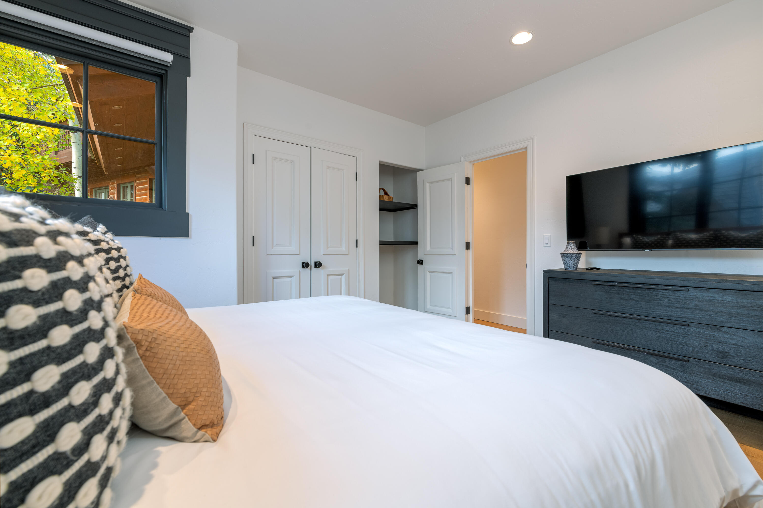 101 Sunny Ridge Place, Unit 101 Mountain Village, CO 81435 - Photo 22 of 30 a bedroom with a bed and a flat screen tv
