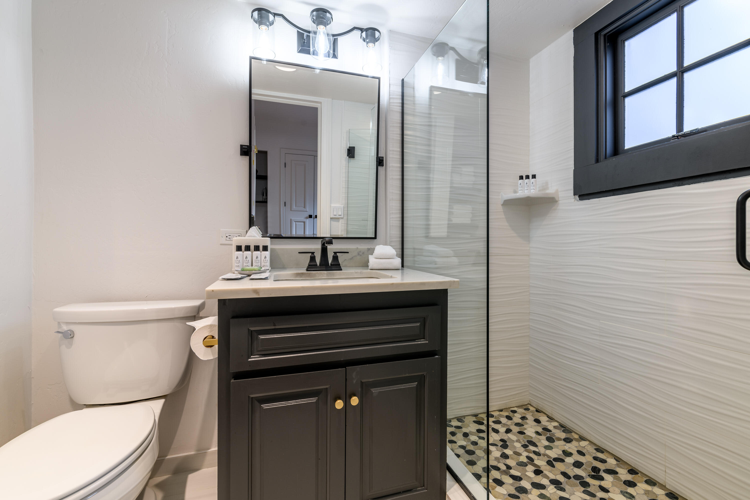 101 Sunny Ridge Place, Unit 101 Mountain Village, CO 81435 - Photo 23 of 30 a bathroom with a sink toilet and shower