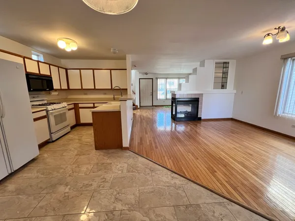 a kitchen with a refrigerator and a stove top oven