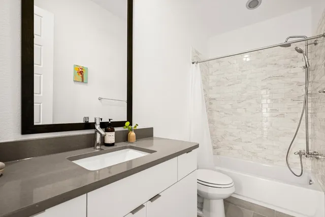 a bedroom with a bed and a desk