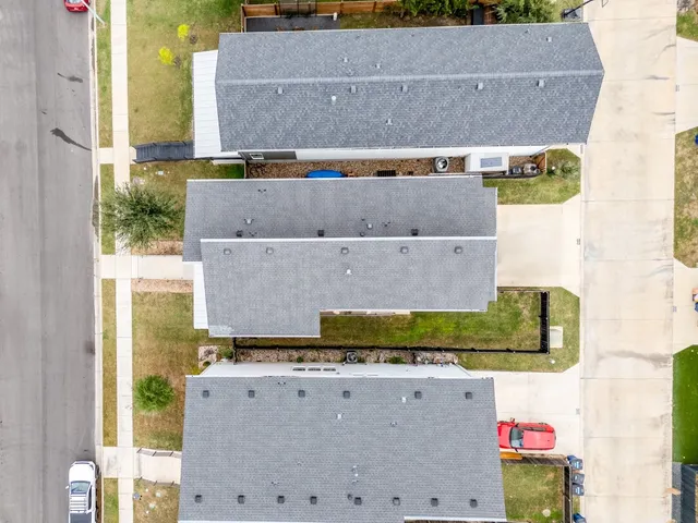 a view of a backyard with wooden fence