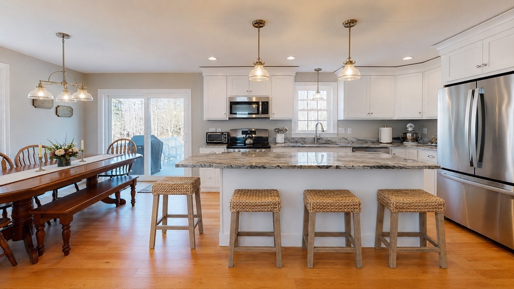 287 Wareham Street Middleboro, MA 02346 - Photo 1 of 28 a kitchen with stainless steel appliances granite countertop a kitchen island a stove a table and chairs