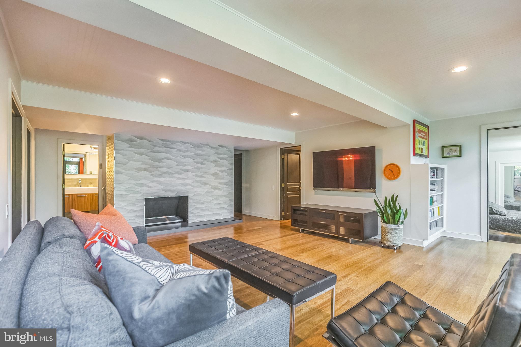27 Forest View Road Rose Valley, PA 19086 - Photo 22 of 39 a living room with furniture and a fireplace