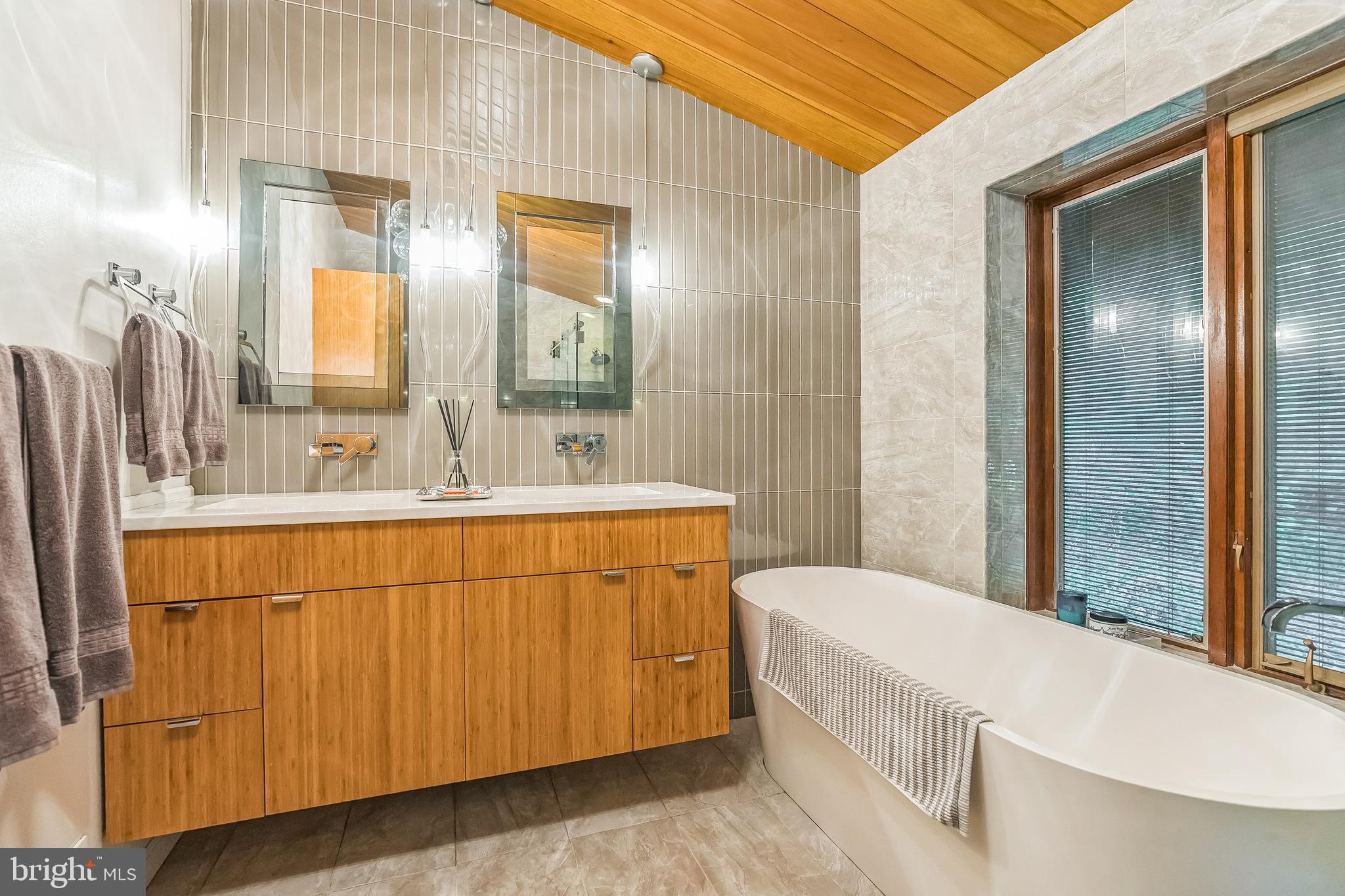 27 Forest View Road Rose Valley, PA 19086 - Photo 36 of 39 a bathroom with a sink a mirror and a bathtub