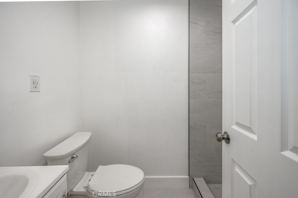 1069 Erringer Road Simi Valley, CA 93065 - Photo 11 of 24 a white toilet sitting next to a shower