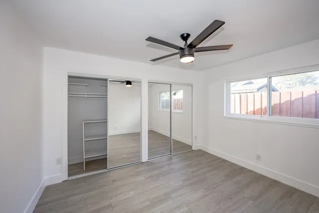 a view of a livingroom with a ceiling fan and window