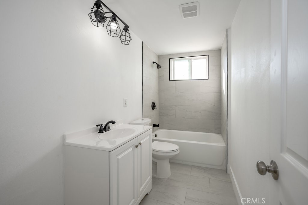 1069 Erringer Road Simi Valley, CA 93065 - Photo 14 of 24 a bathroom with a sink a toilet and shower