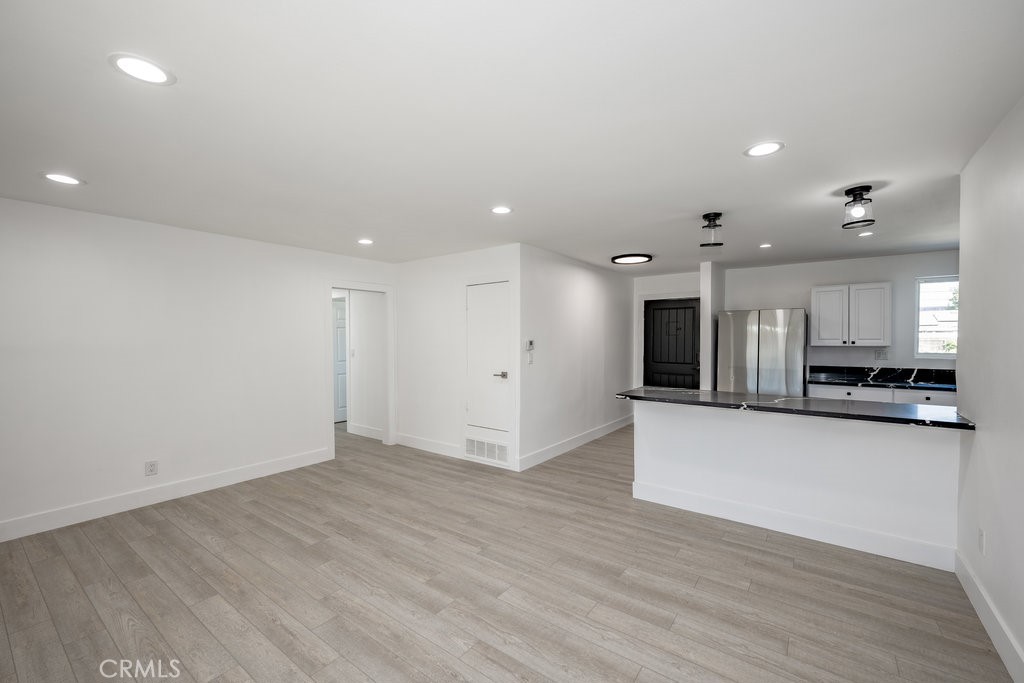 1069 Erringer Road Simi Valley, CA 93065 - Photo 4 of 24 a view of kitchen with kitchen island wooden floor appliances and cabinets