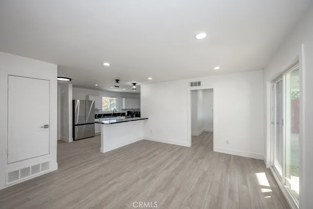 a kitchen with stainless steel appliances refrigerator sink and cabinets