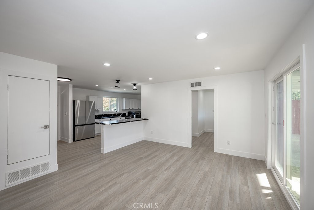1069 Erringer Road Simi Valley, CA 93065 - Photo 7 of 24 a kitchen with stainless steel appliances refrigerator sink and cabinets