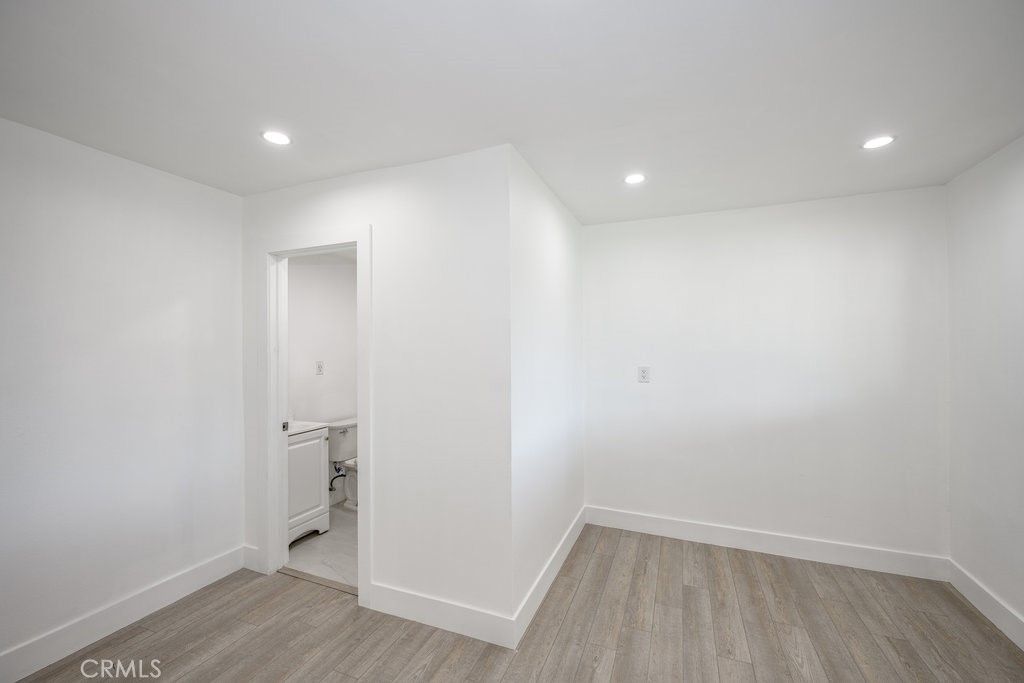 1069 Erringer Road Simi Valley, CA 93065 - Photo 9 of 24 wooden floor in an empty room with a window