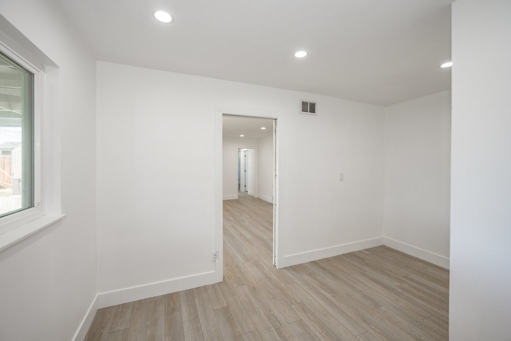 1069 Erringer Road Simi Valley, CA 93065 - Photo 10 of 24 wooden floor in an empty room with a window