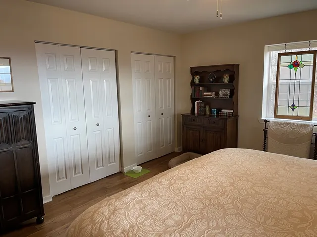 a spacious bathroom with a double vanity sink toilet mirror and shower