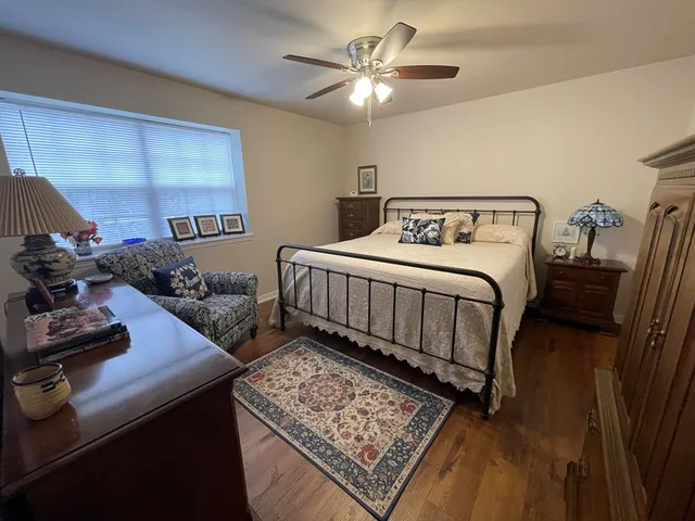 a bathroom with a granite countertop sink mirror vanity and toilet