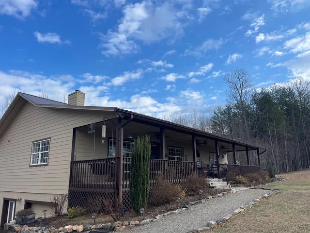a front view of a house with yard and sitting area