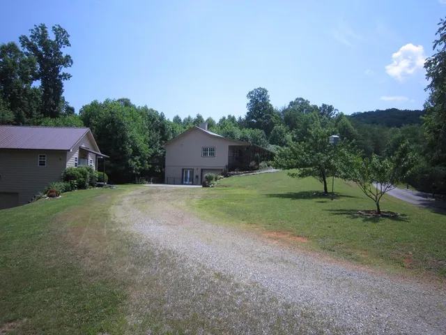 a view of a house with a yard and a garage
