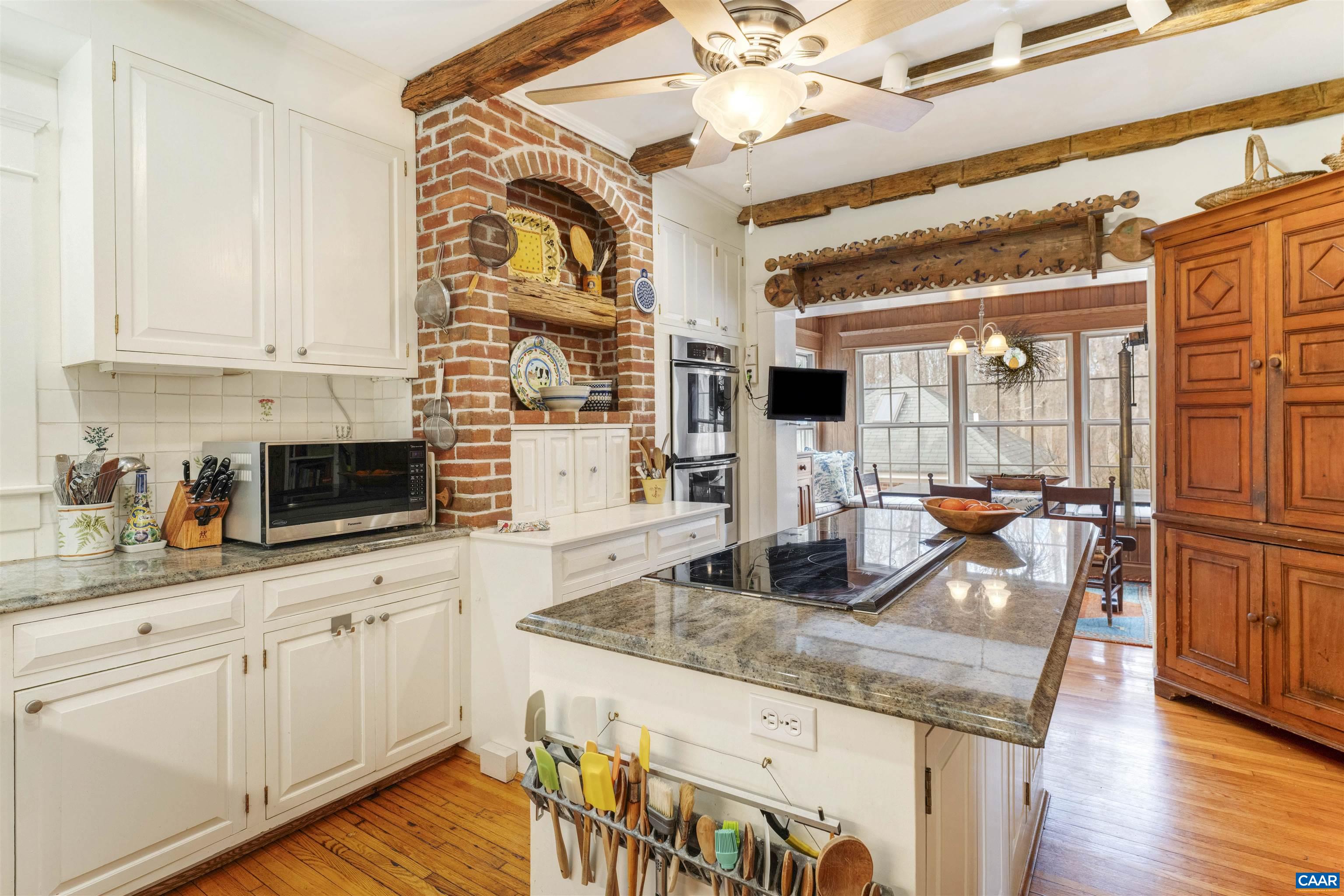 4035 Edge Valley Road North Garden, VA 22959 - Photo 26 of 57 a kitchen with granite countertop a sink a stove and cabinets