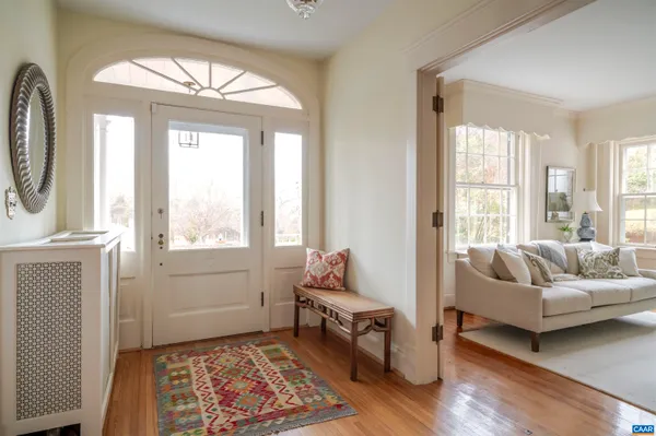 a living room with furniture fireplace and a large window