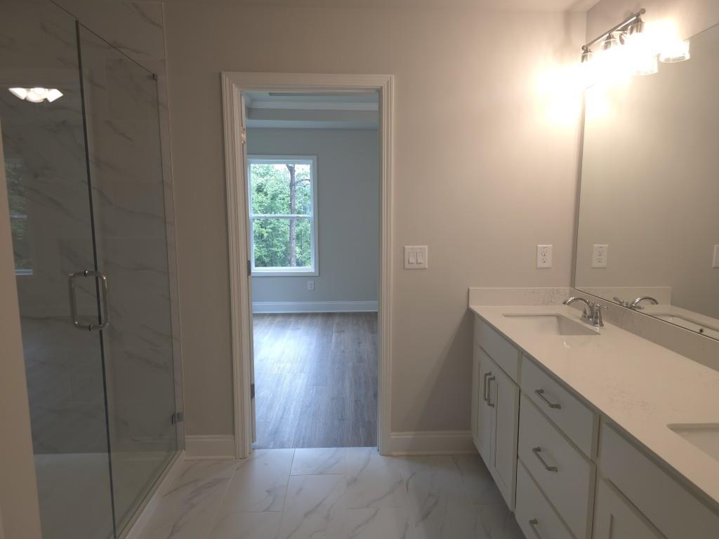 4240 Cavalier Way Duluth, GA 30097 - Photo 30 of 46 a bathroom with a double vanity sink and a mirror