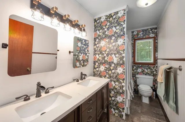 a bathroom with a sink double vanity and a mirror