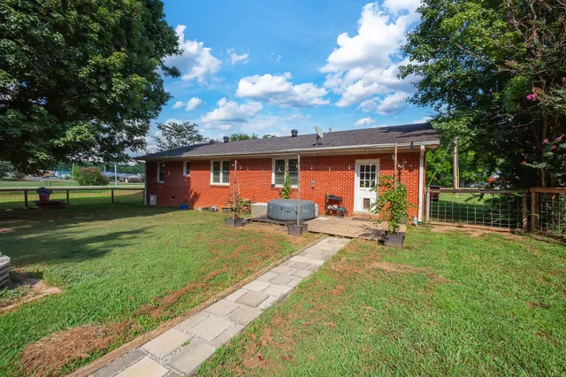 a view of a house with backyard sitting area and garden