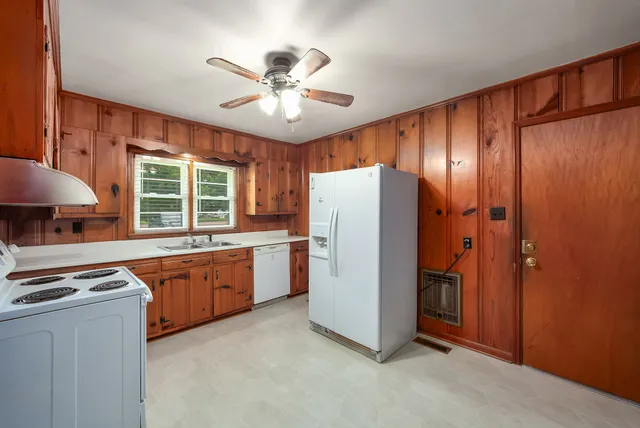 a kitchen with refrigerator a stove a sink and dishwasher