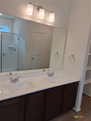 a view of a closet with wooden floor