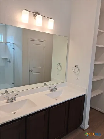 a bathroom with a glass shower door