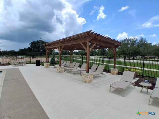 a view of a swimming pool with lounge chairs