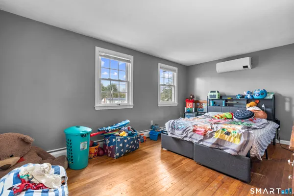 a bedroom with bed and a window