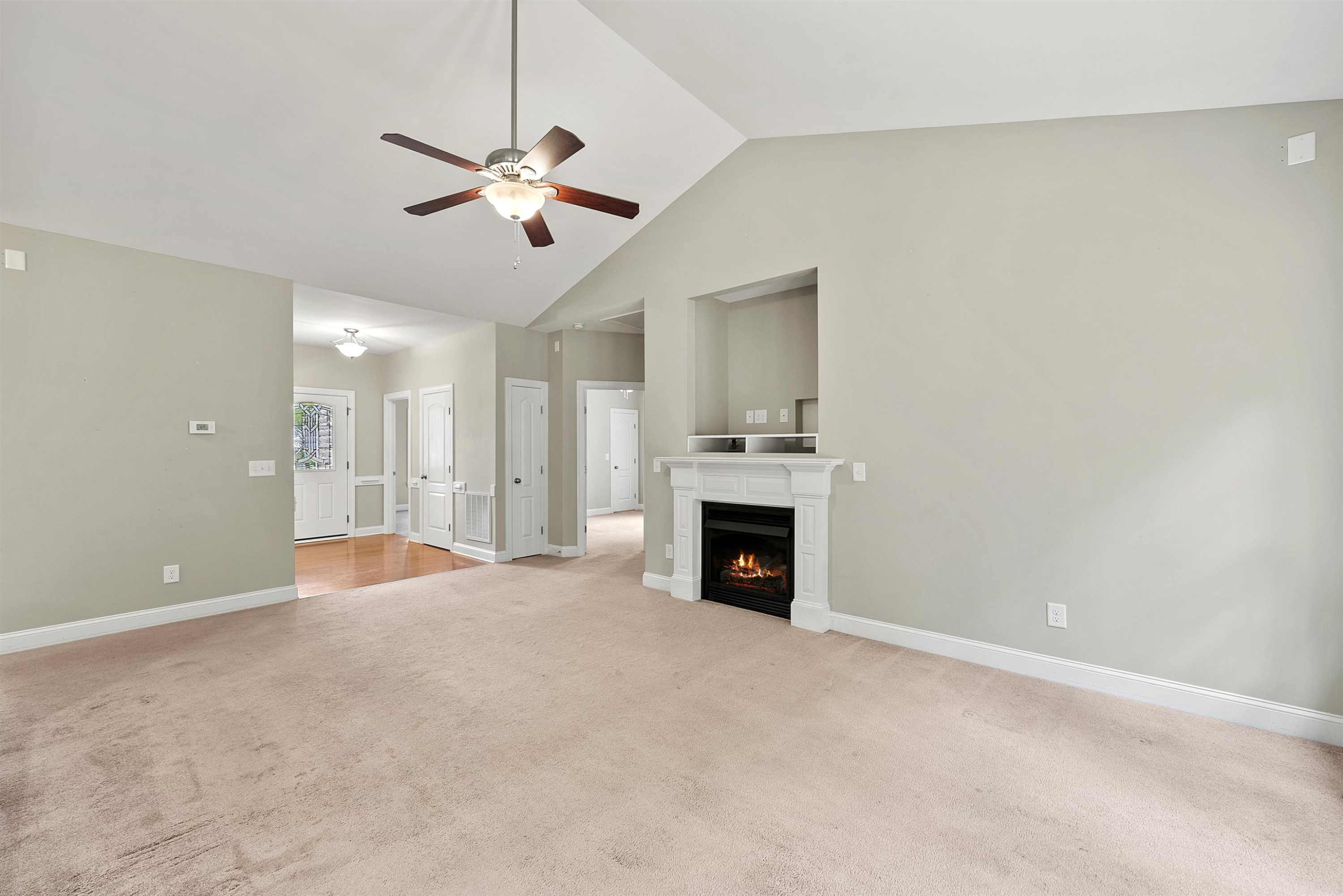 135 Rawhide Drive Spring Hope, NC 27882 - Photo 12 of 34 a view of an empty room with a fireplace and a ceiling fan