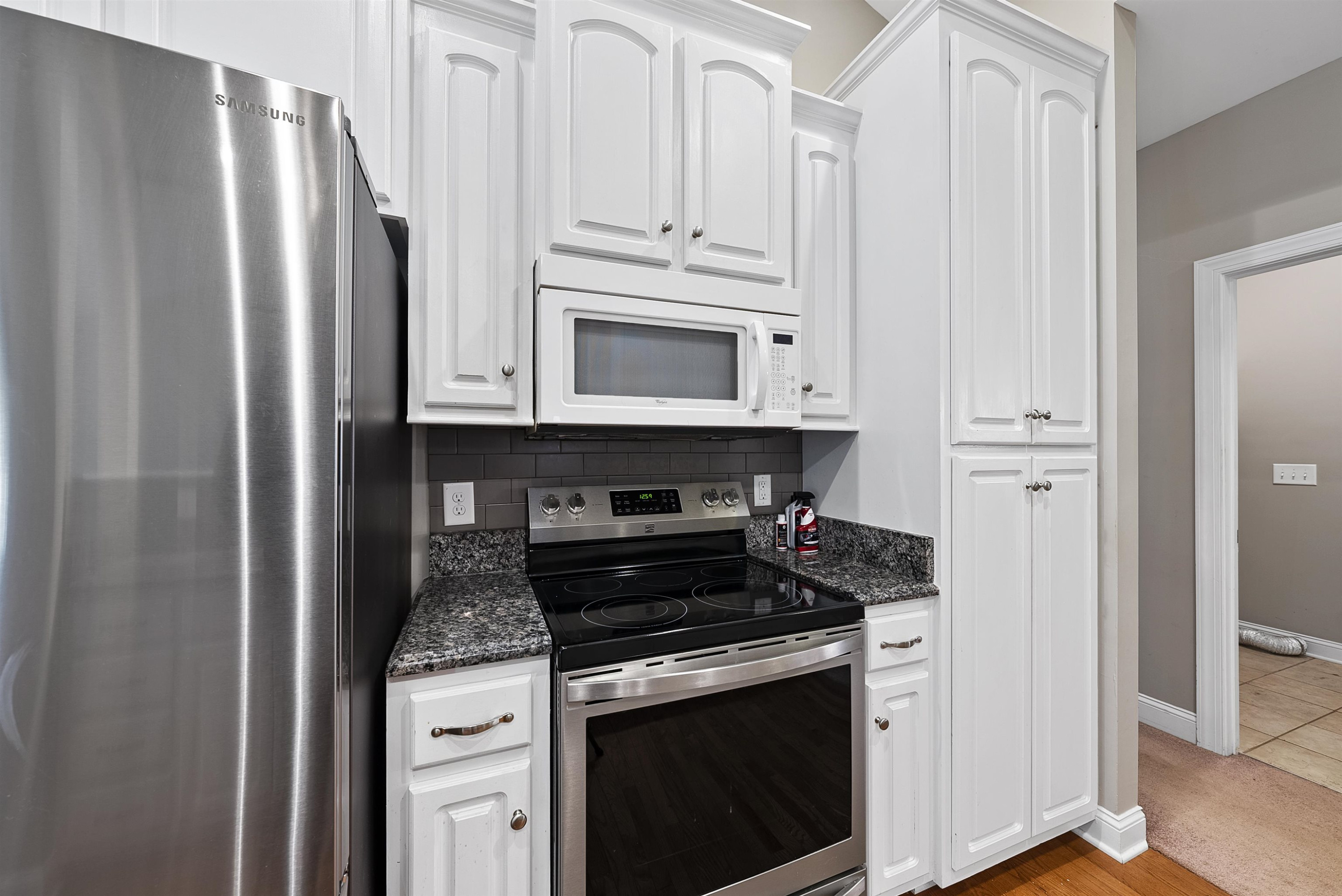 135 Rawhide Drive Spring Hope, NC 27882 - Photo 17 of 34 a kitchen with stainless steel appliances granite countertop white cabinets and refrigerator