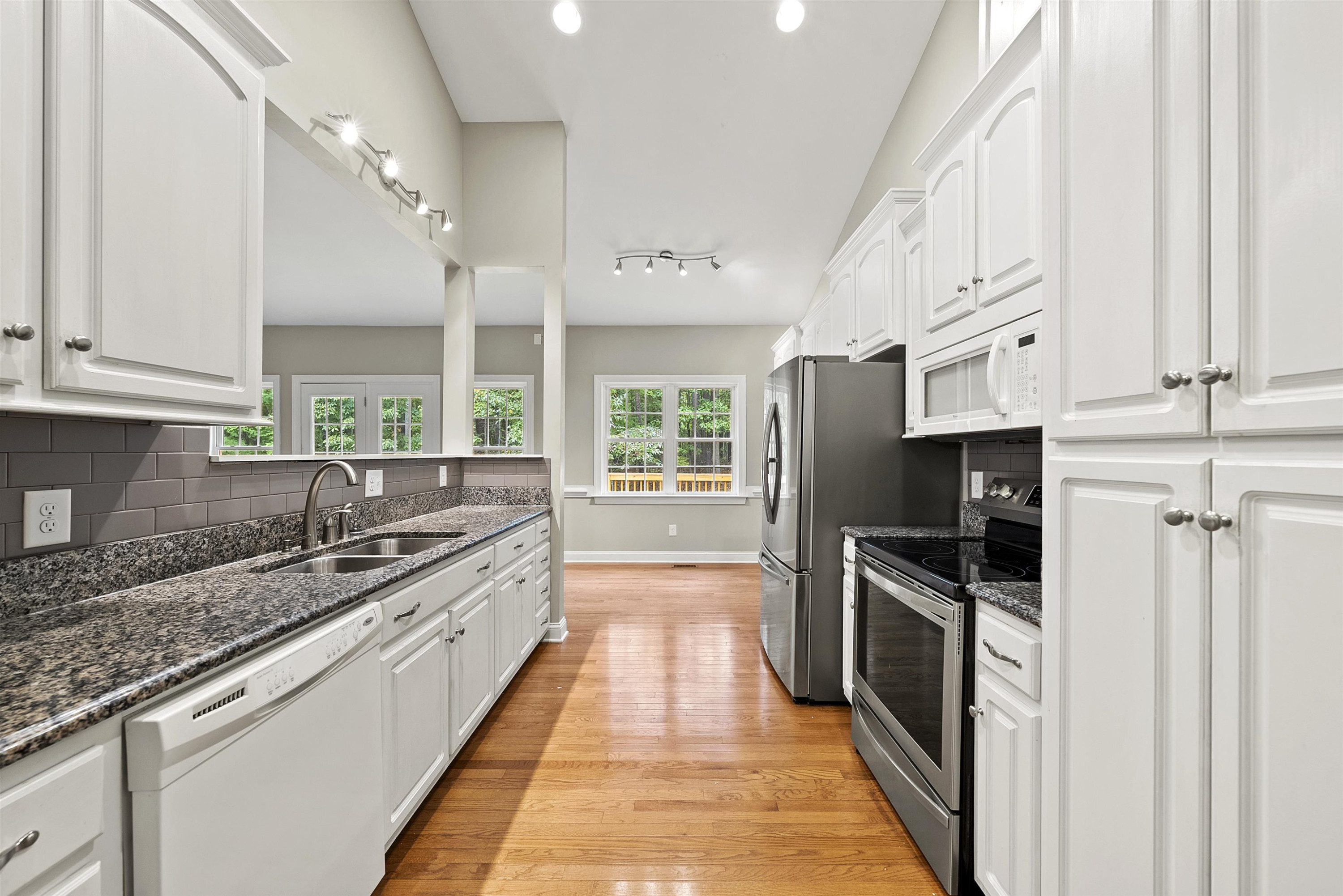 135 Rawhide Drive Spring Hope, NC 27882 - Photo 18 of 34 a kitchen with stainless steel appliances granite countertop a sink and a stove
