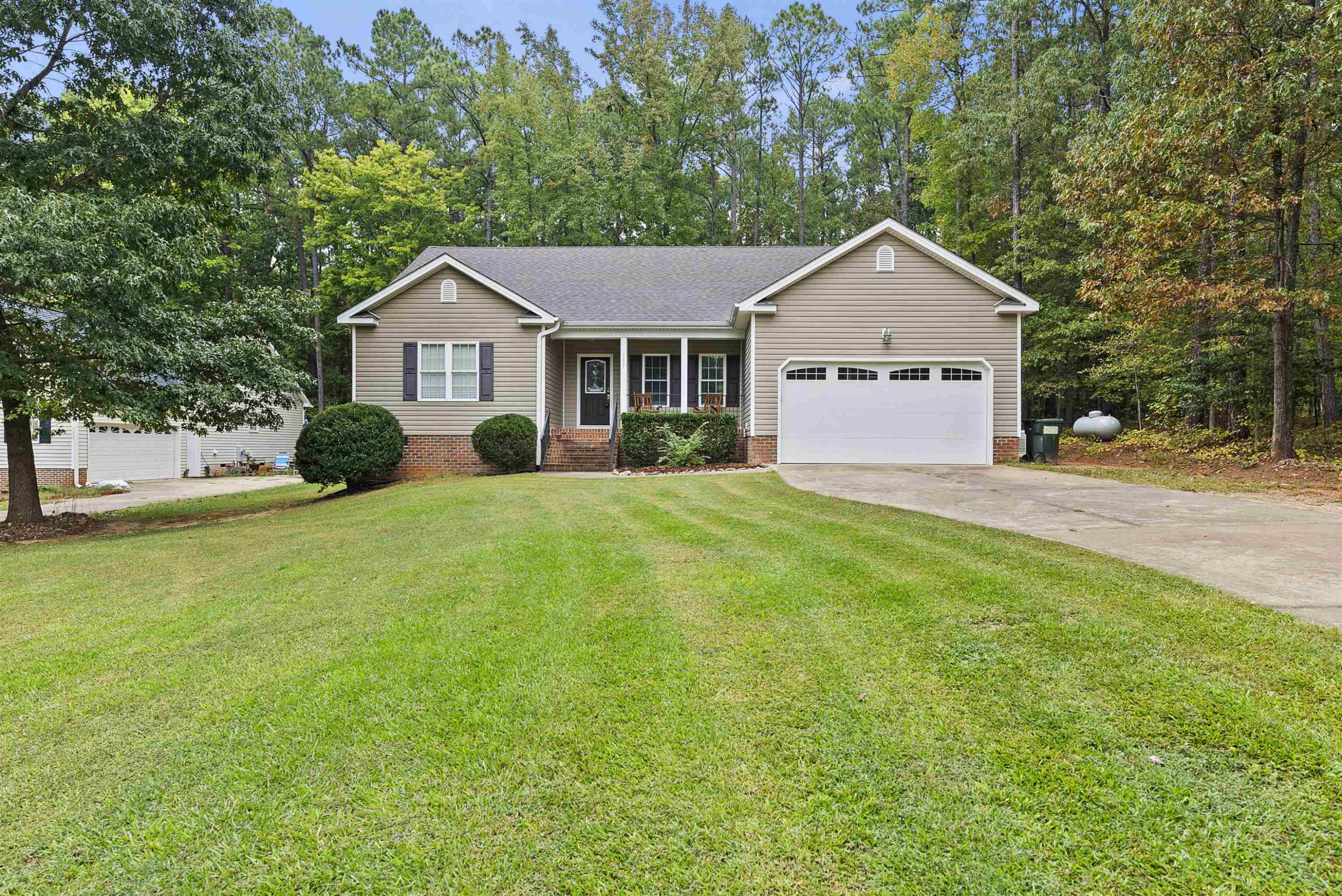135 Rawhide Drive Spring Hope, NC 27882 - Photo 2 of 34 a front view of a house with yard and green space