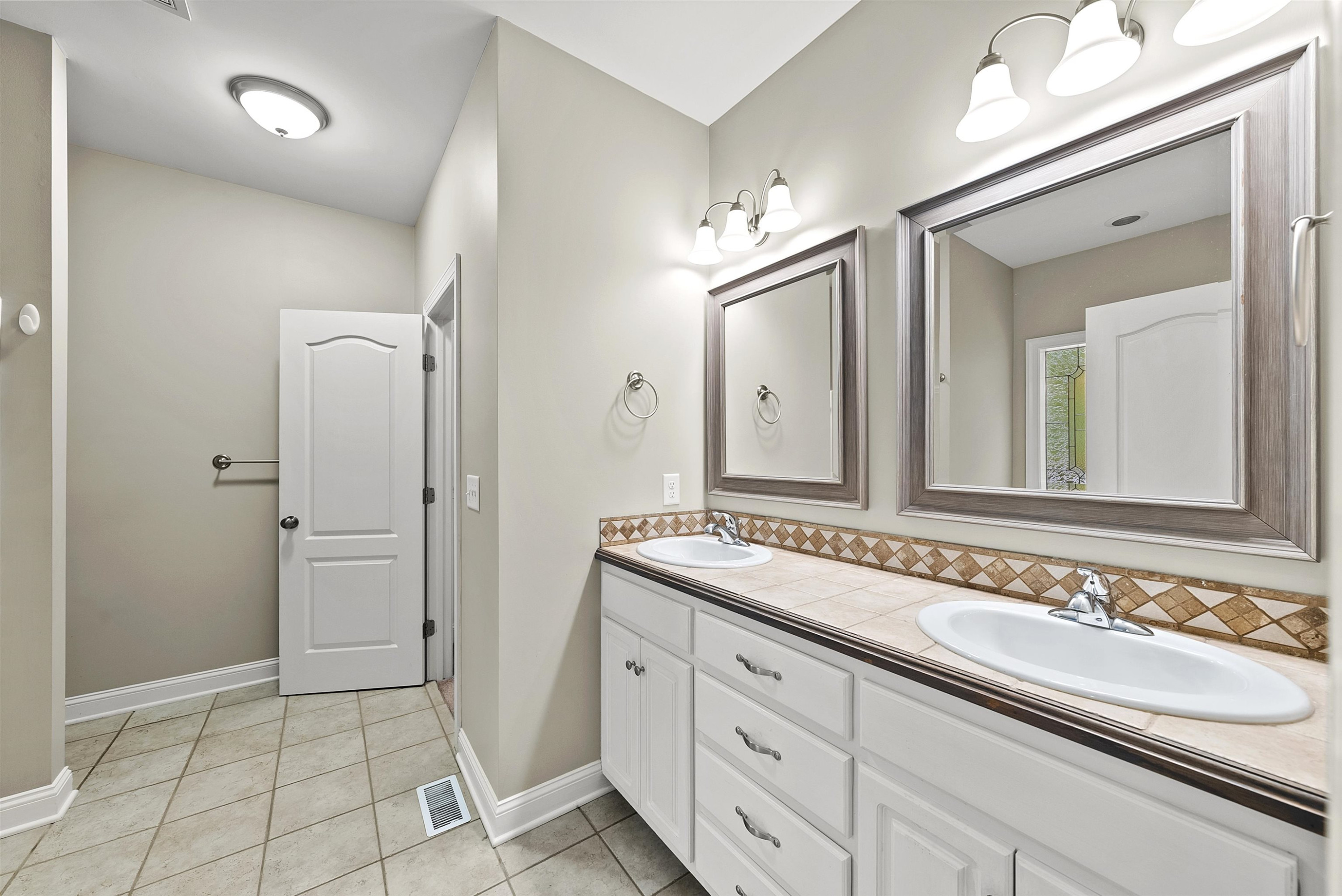 135 Rawhide Drive Spring Hope, NC 27882 - Photo 22 of 34 a bathroom with a sink and a mirror