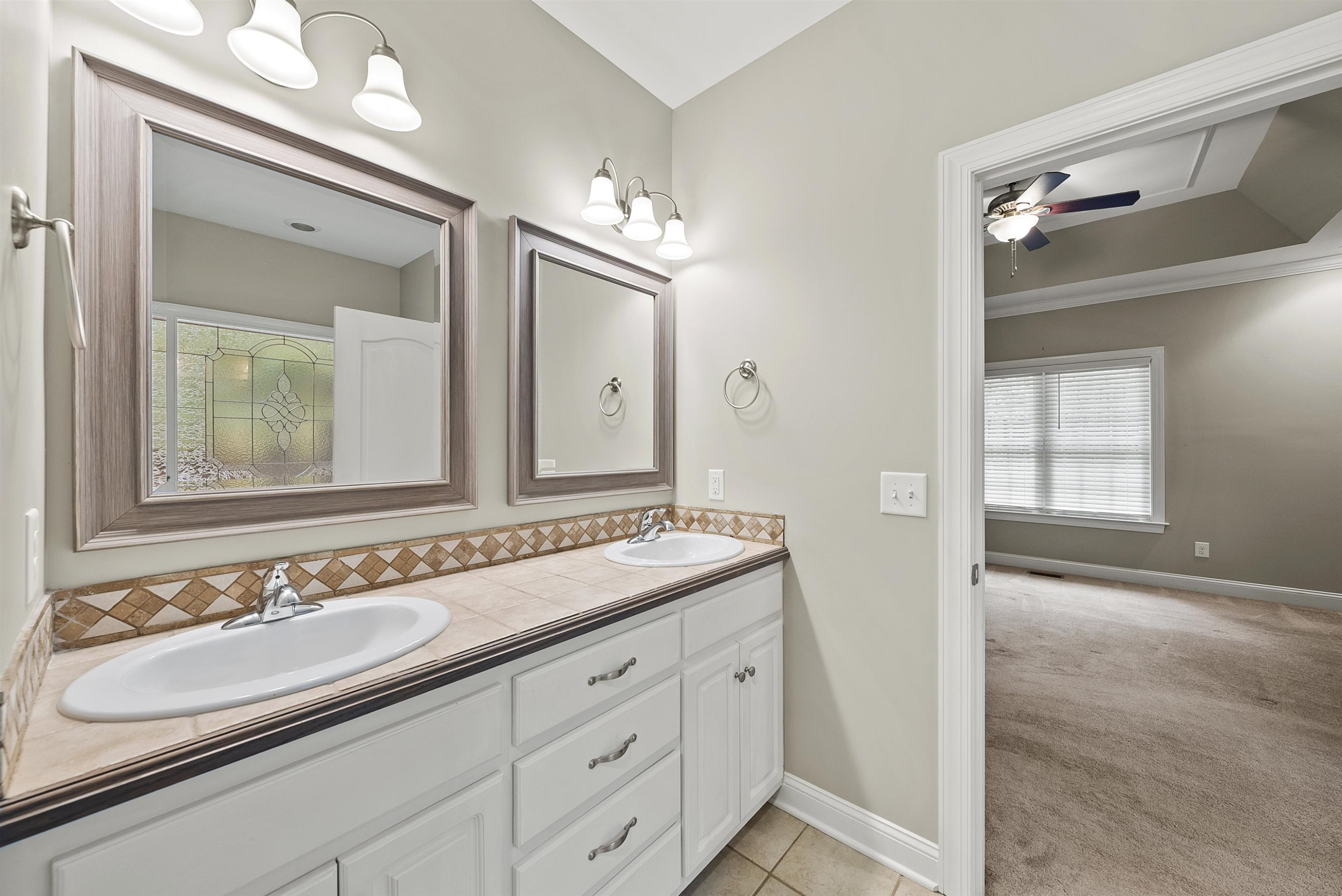 135 Rawhide Drive Spring Hope, NC 27882 - Photo 24 of 34 a bathroom with a sink double vanity and a mirror