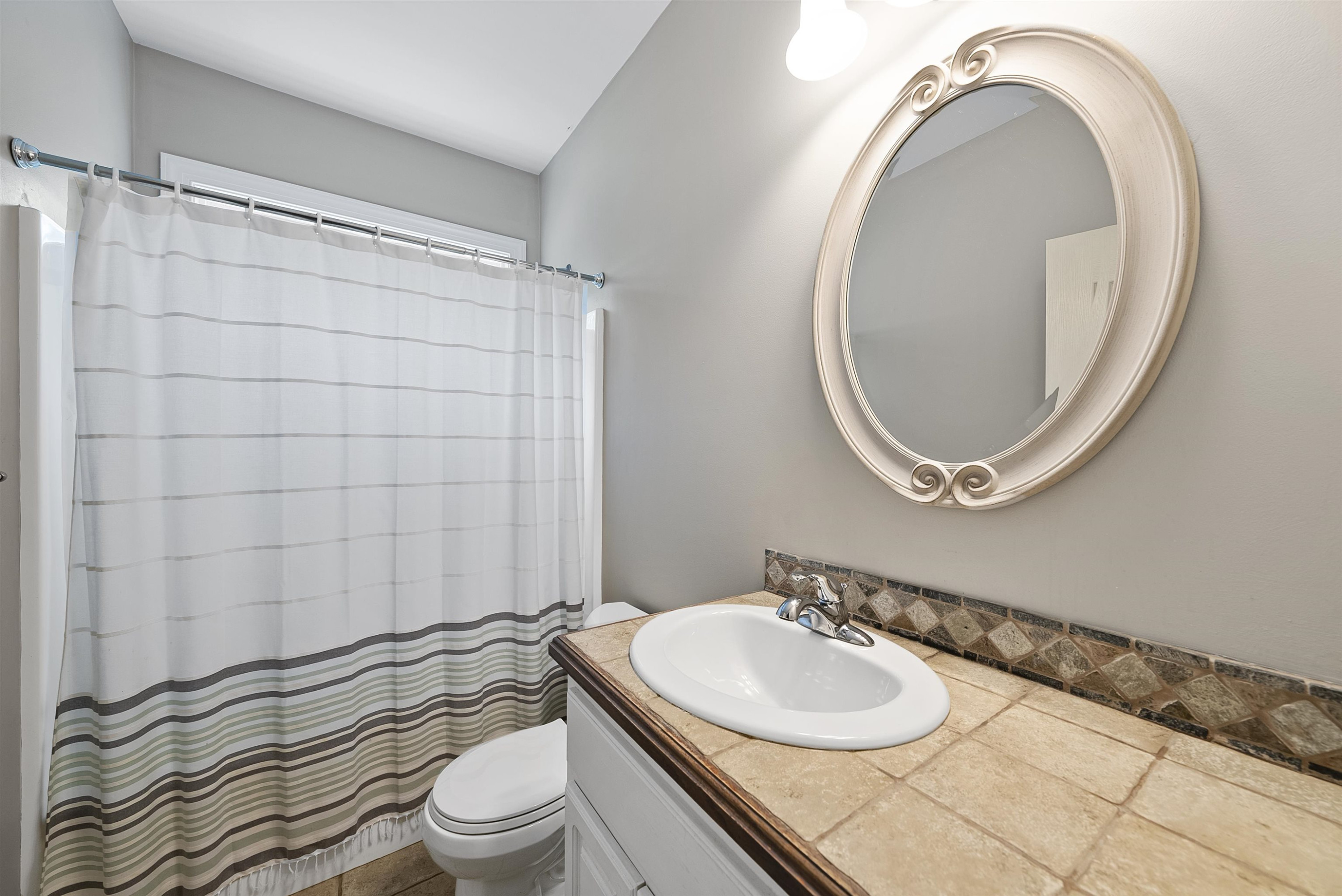 135 Rawhide Drive Spring Hope, NC 27882 - Photo 28 of 34 a bathroom with a sink a toilet and a mirror