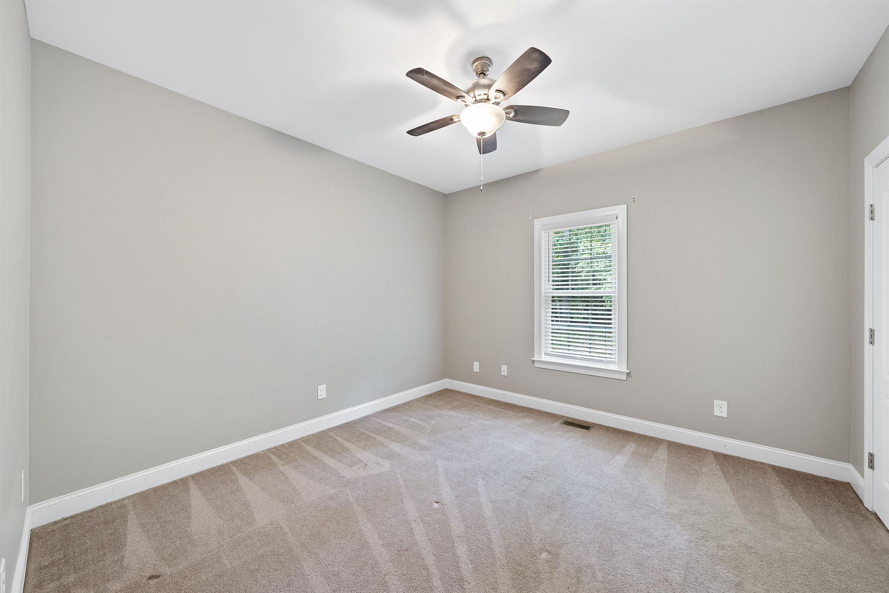 135 Rawhide Drive Spring Hope, NC 27882 - Photo 29 of 34 an empty room with a window and a fan