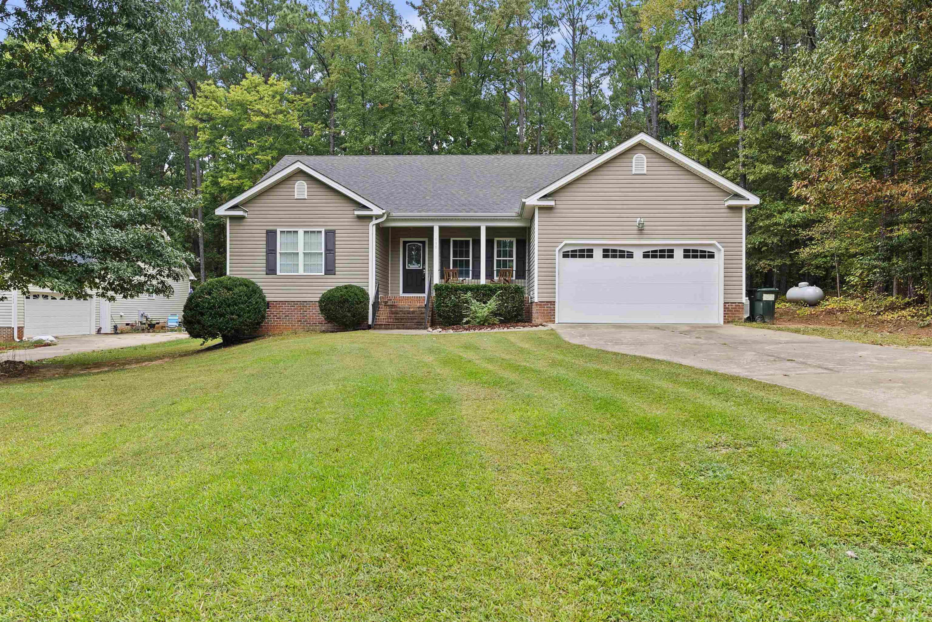 135 Rawhide Drive Spring Hope, NC 27882 - Photo 3 of 34 a front view of a house with yard and green space