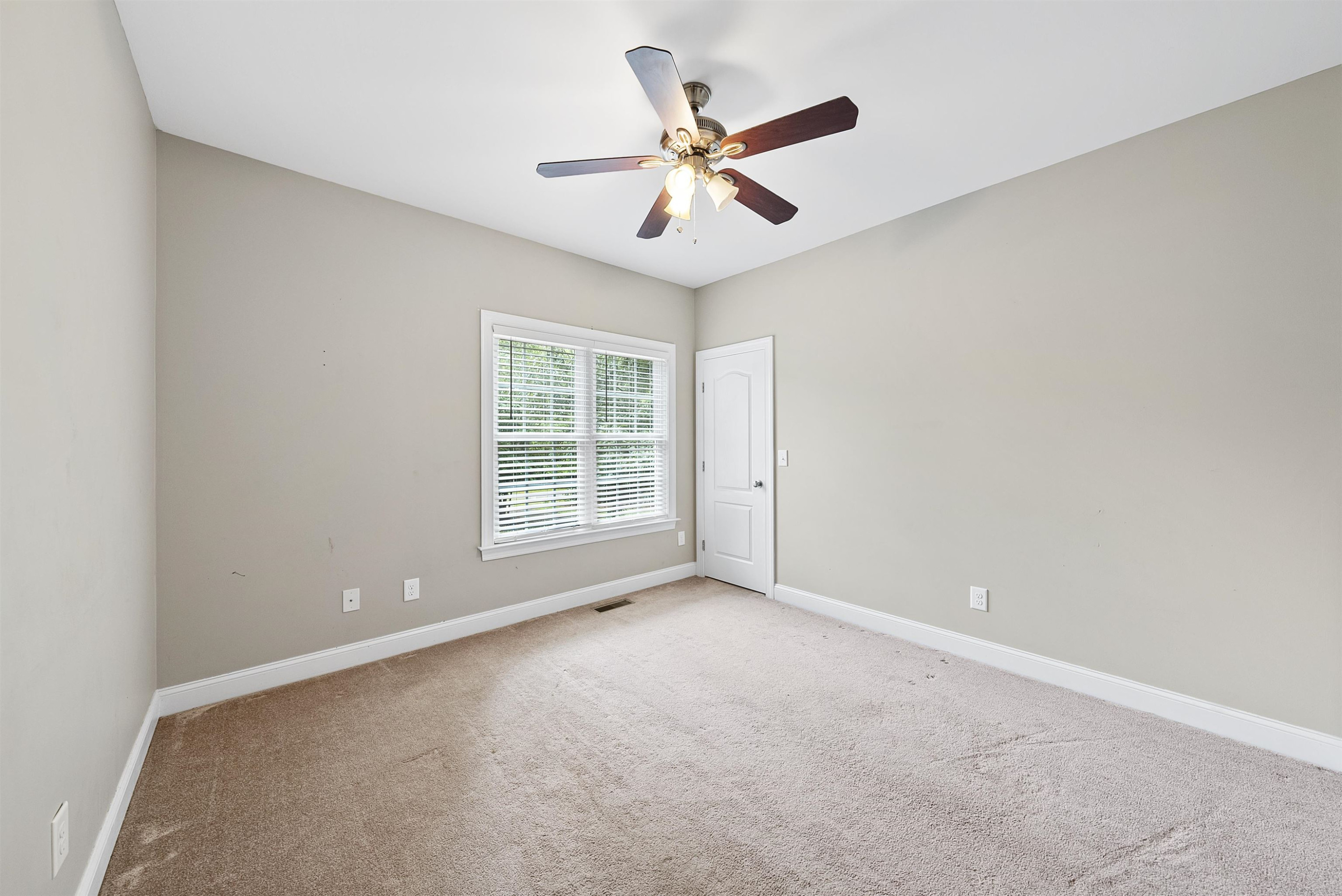 135 Rawhide Drive Spring Hope, NC 27882 - Photo 7 of 34 an empty room with a ceiling fan and window