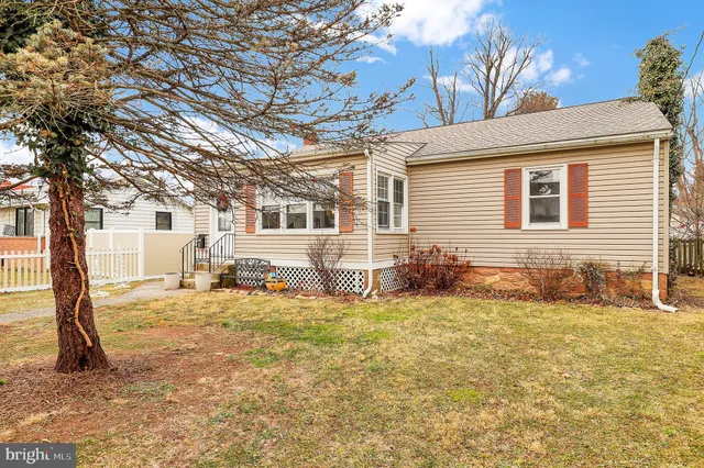 a view of a livingroom with lounge chair and a large window