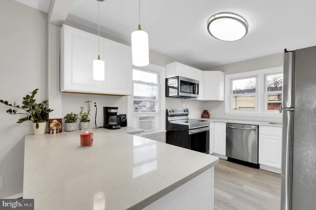 a kitchen with stainless steel appliances a stove microwave and cabinets