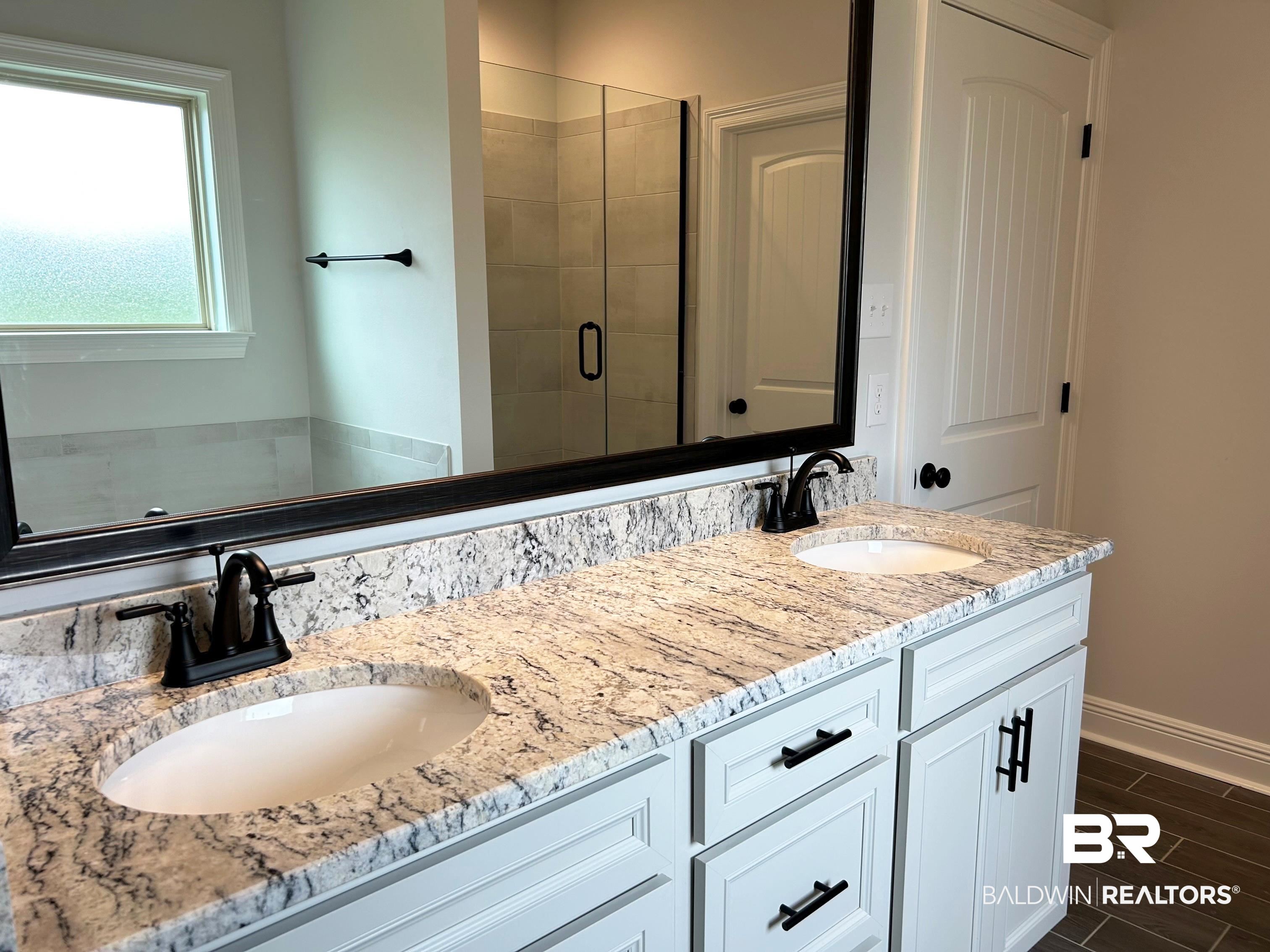 876 Sumter Loop Foley, AL 36535 - Photo 13 of 24 Bathroom featuring vanity and a shower with shower door