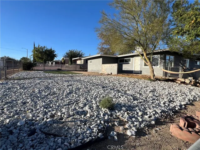 a backyard of a house with lots of plants and trees