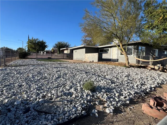 a backyard of a house with lots of plants and trees
