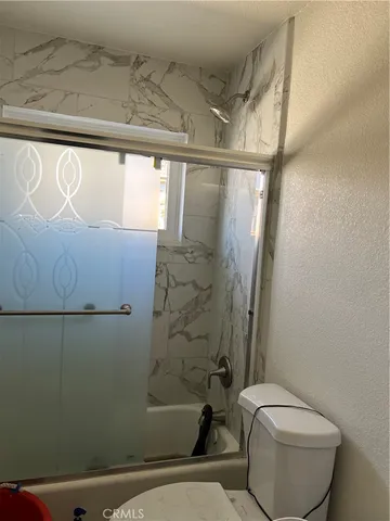 a bathroom with a toilet and shower